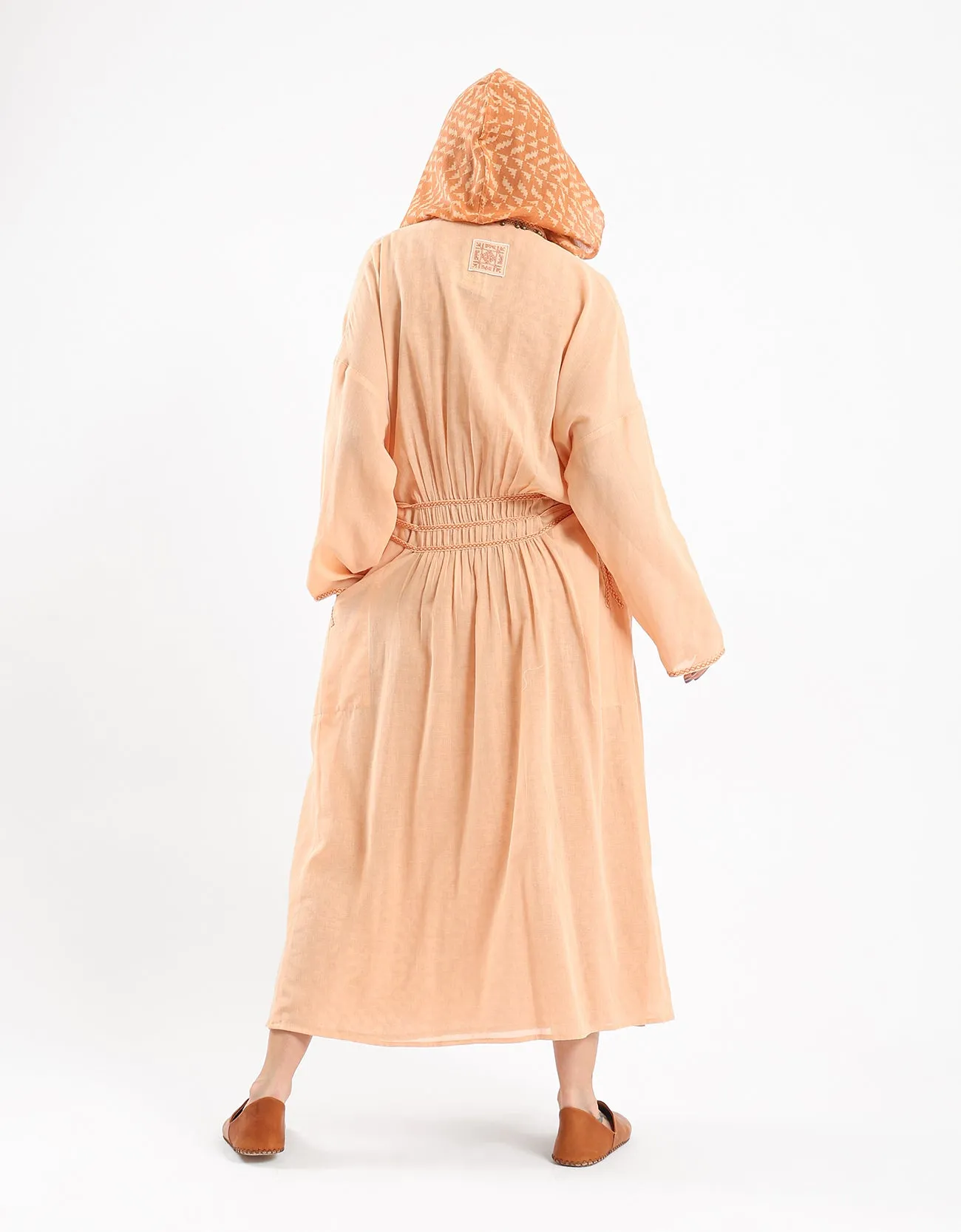 Long draped coat with decorative stitching details on the belt