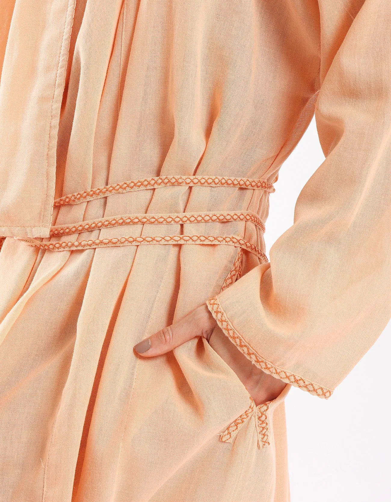 Long draped coat with decorative stitching details on the belt