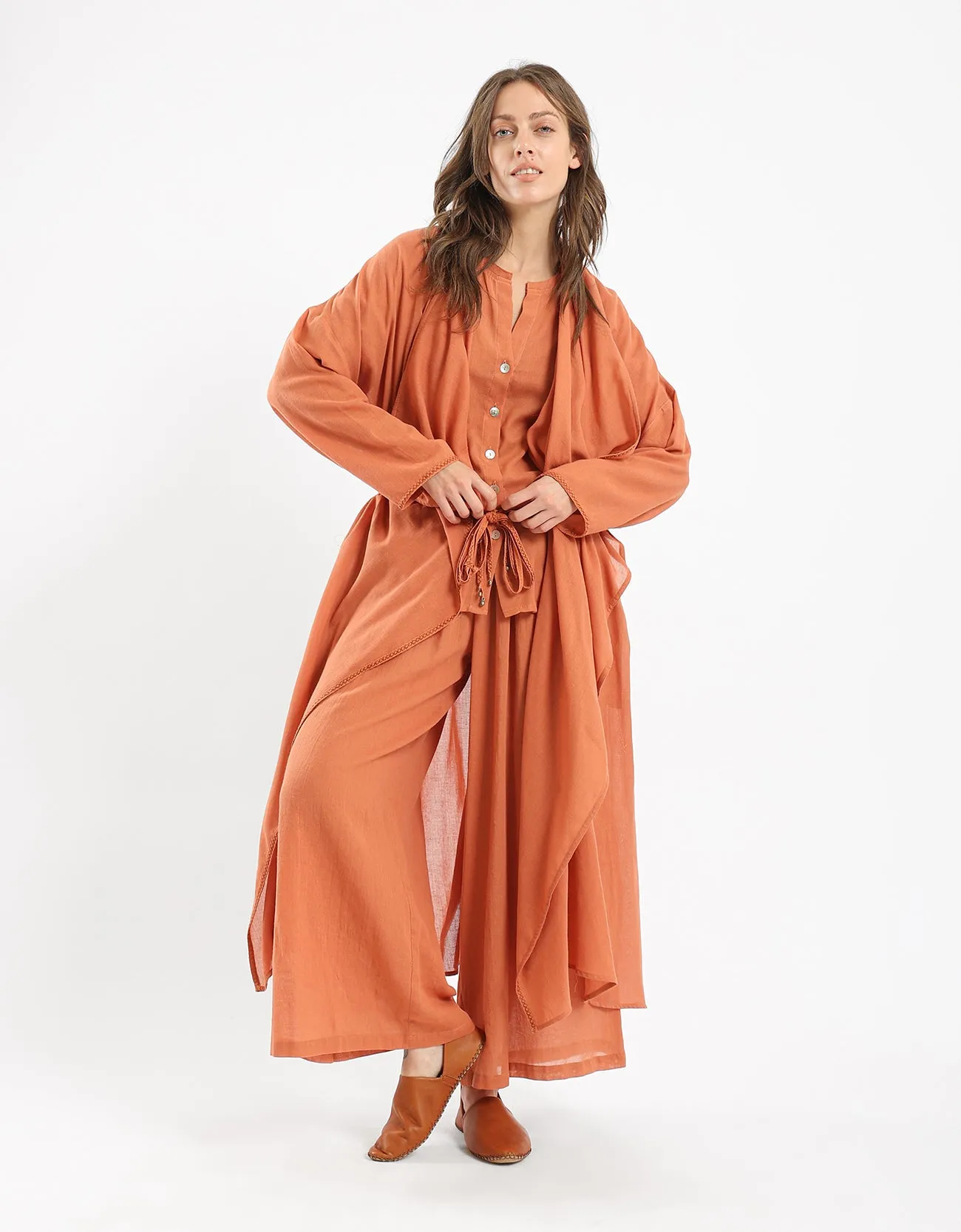 Long draped coat with decorative stitching details on the belt