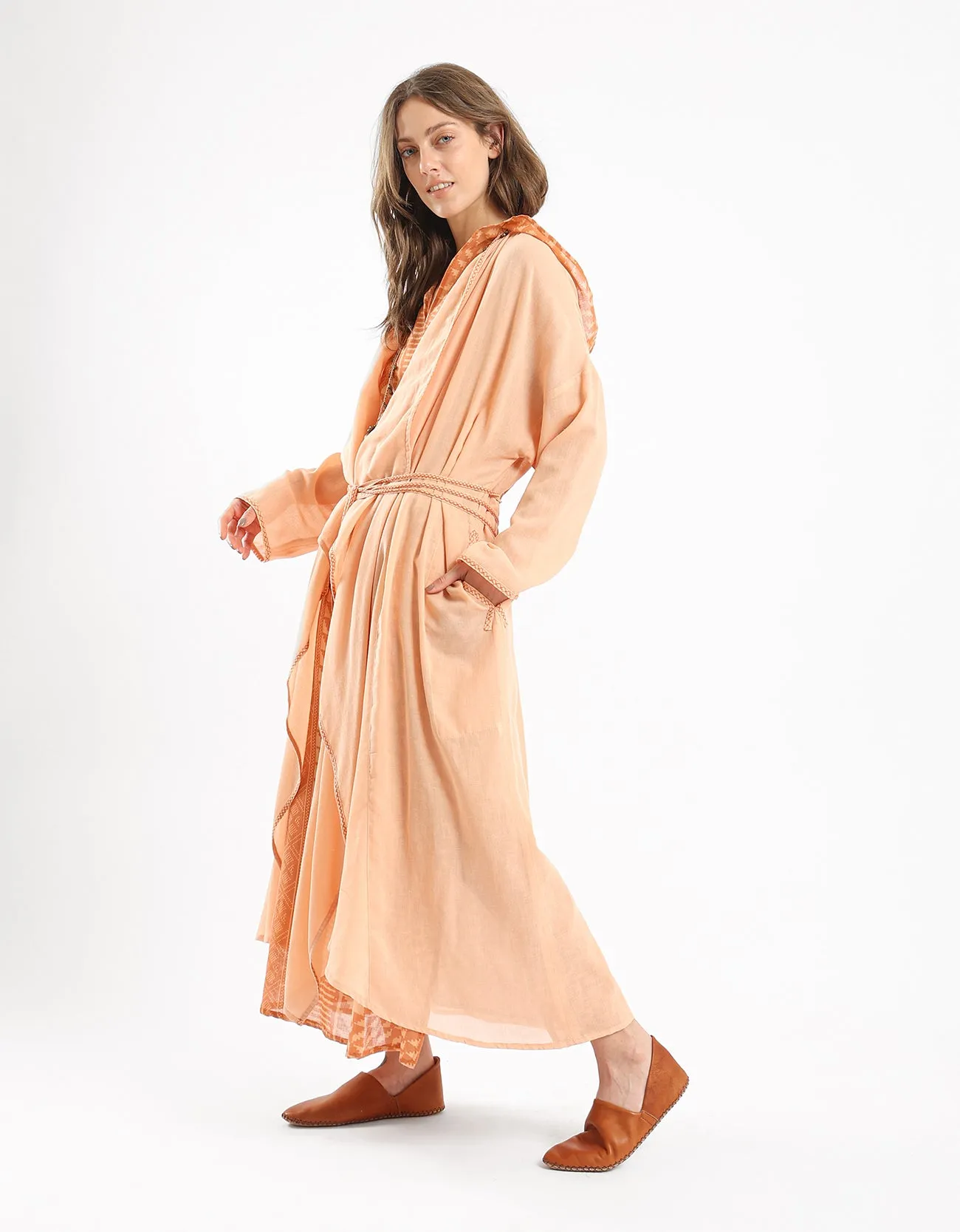 Long draped coat with decorative stitching details on the belt