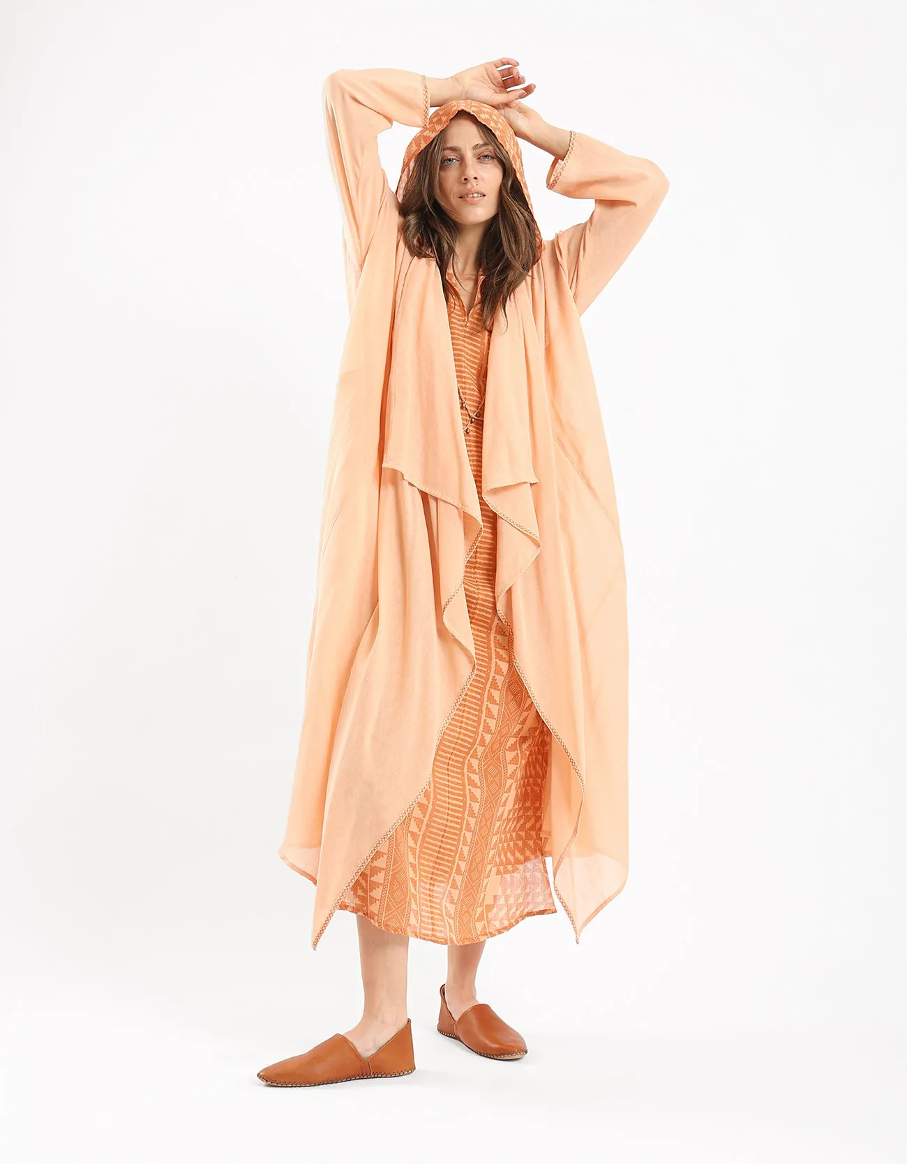 Long draped coat with decorative stitching details on the belt