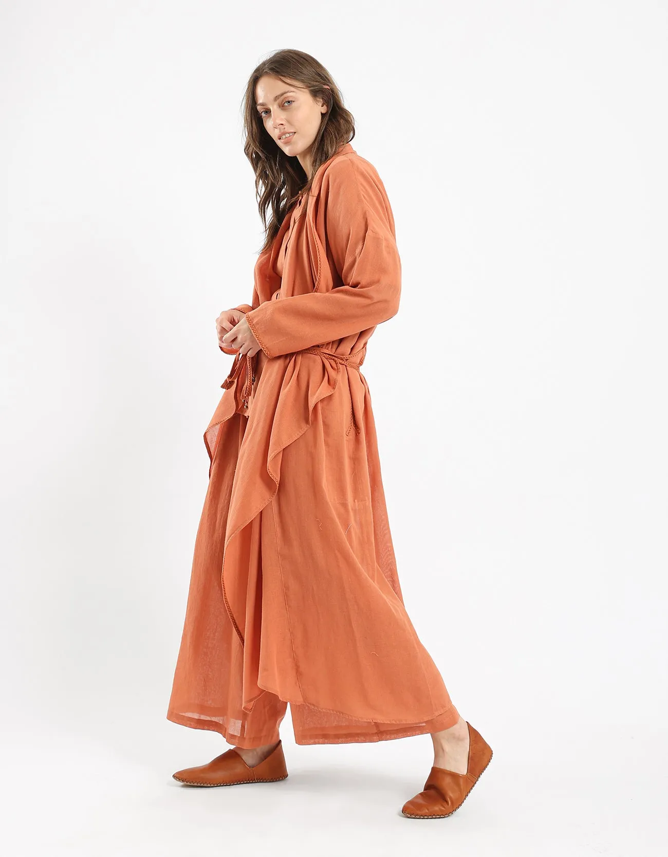 Long draped coat with decorative stitching details on the belt