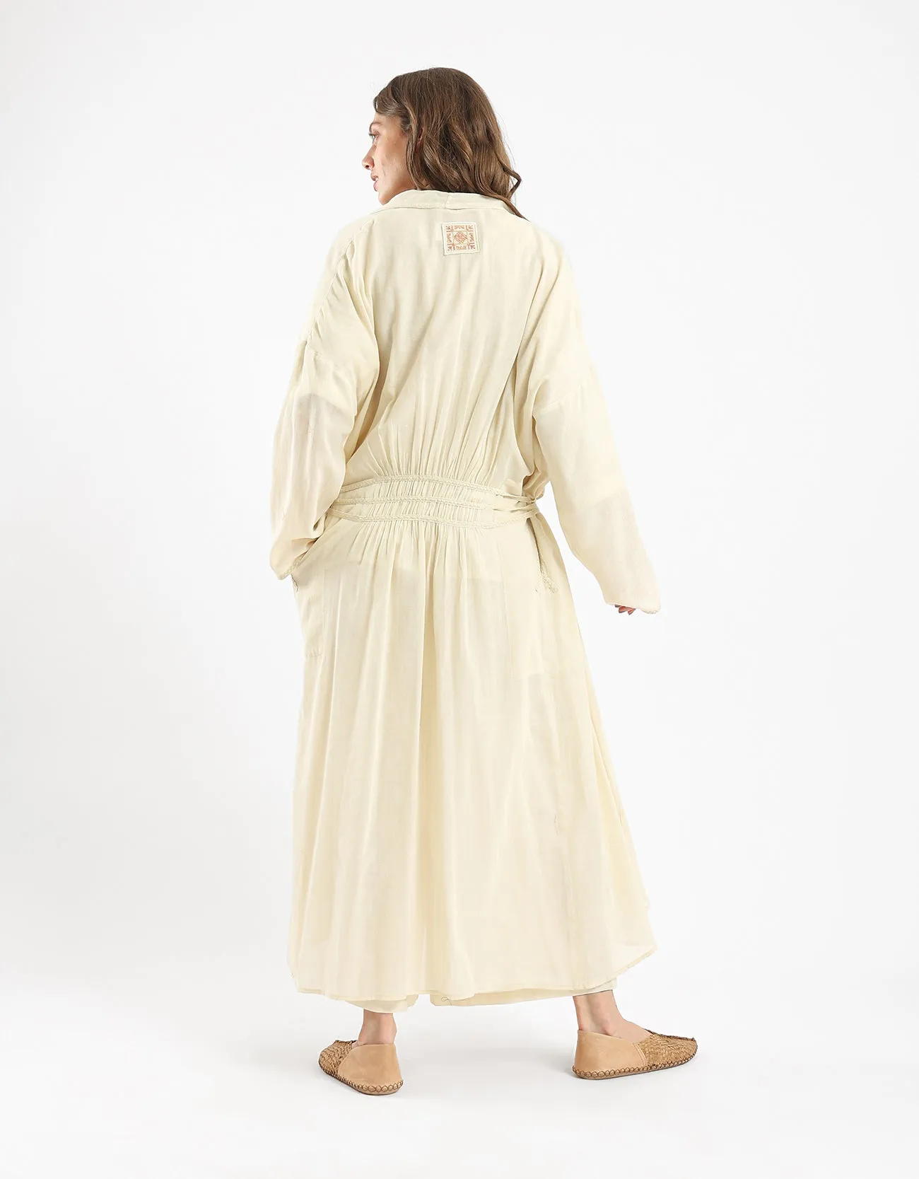 Long draped coat with decorative stitching details on the belt