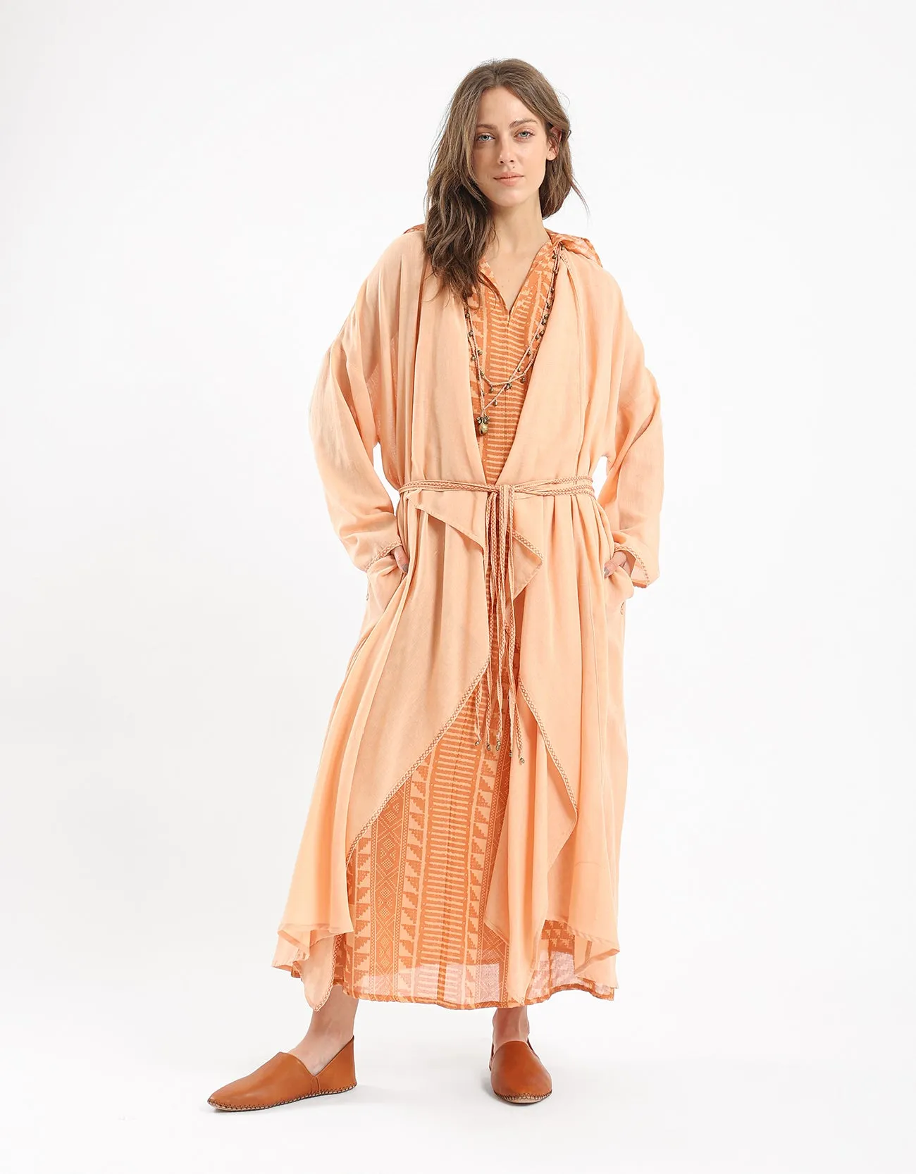 Long draped coat with decorative stitching details on the belt