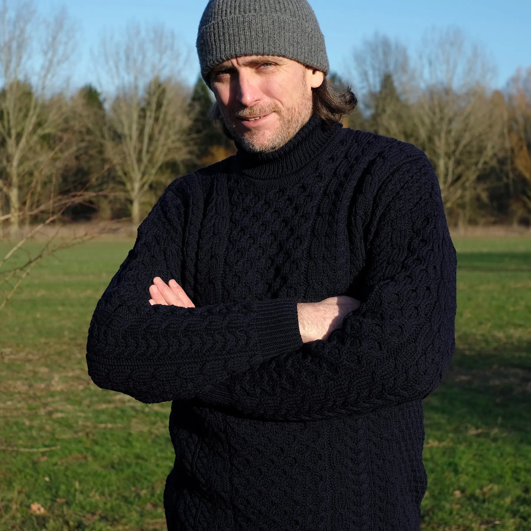 Traditional Aran polo neck sweater in Navy