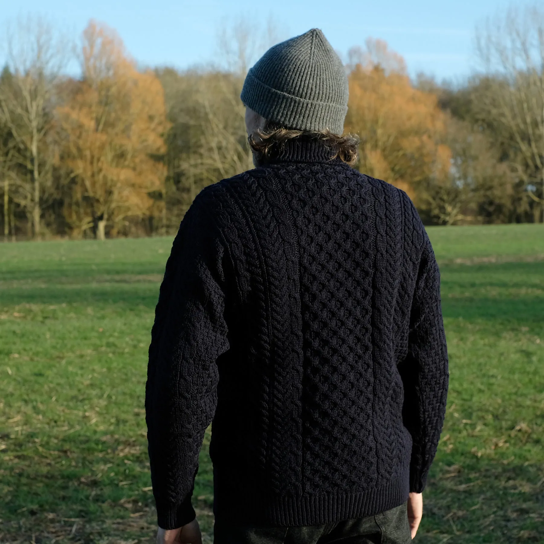 Traditional Aran polo neck sweater in Navy